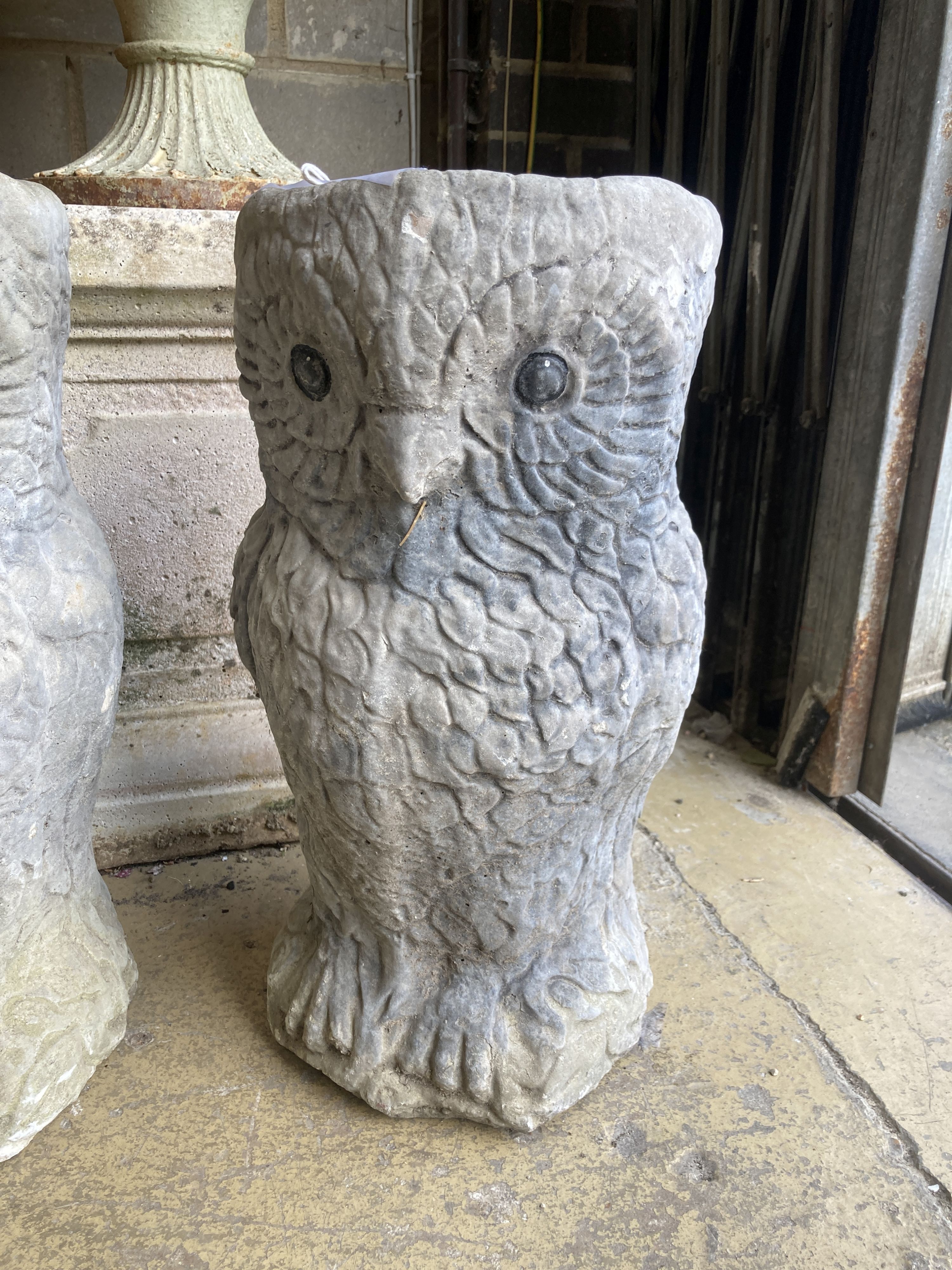 A pair of reconstituted stone owl garden planters, height 50cm